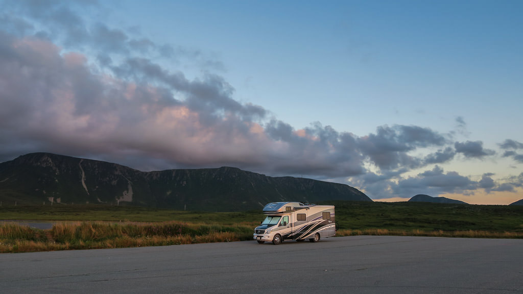 Winnebago View parked with colorful skies above