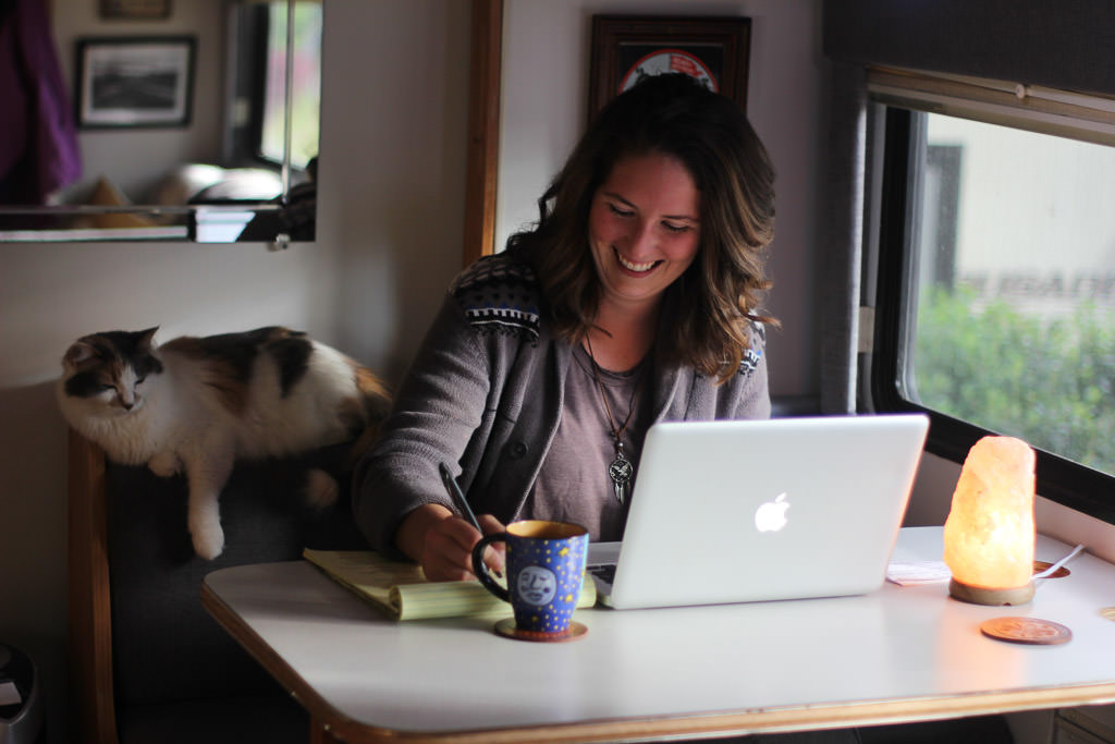 Melanie working on her laptop at the dinette.