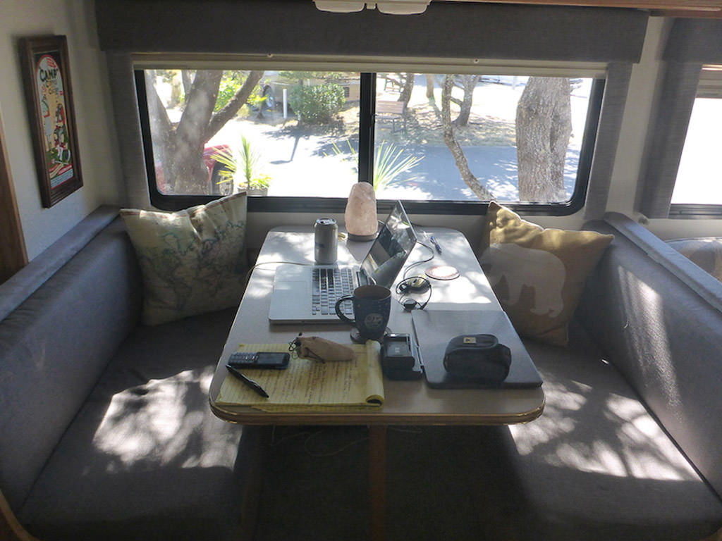 Dinette area set up as a workspace with a laptop.