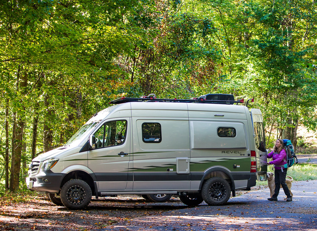 Kathy closing the rear door of Winnebago Revel.