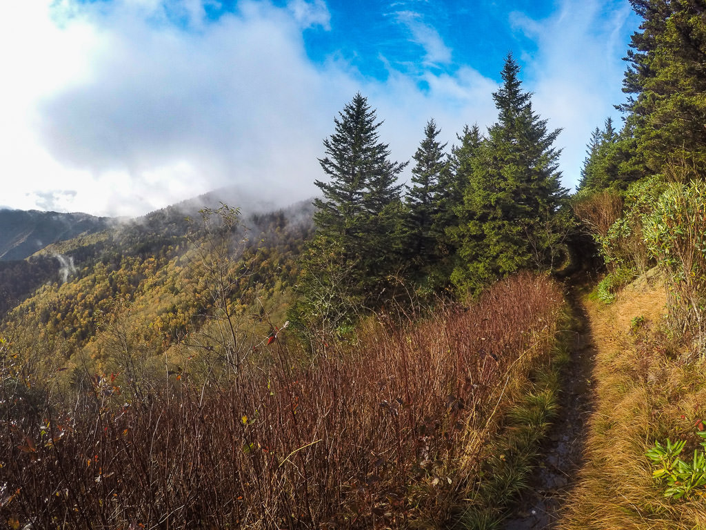Clouds covering the top of the mountain tops. 