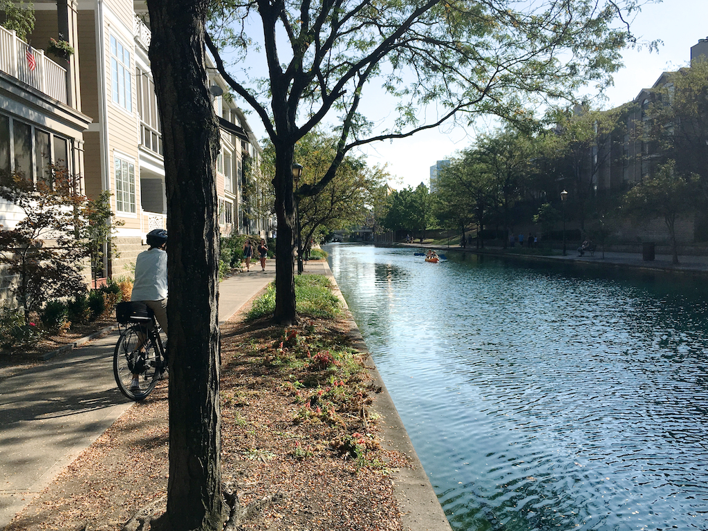Biker stopped on trail next to refurbished canal