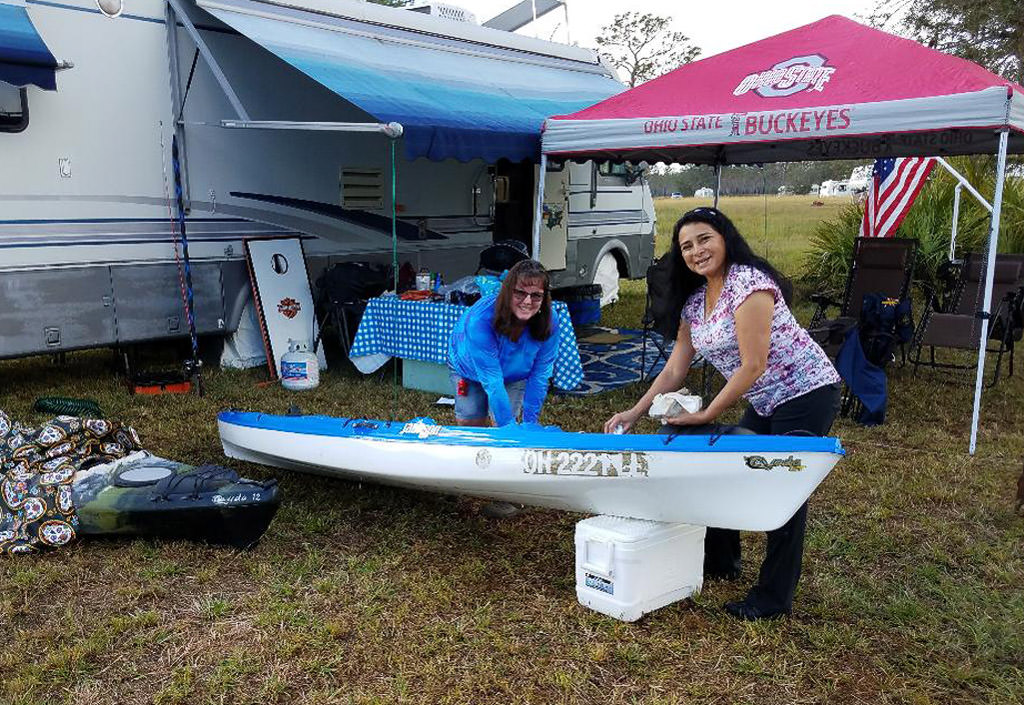 Two people getting kayak ready