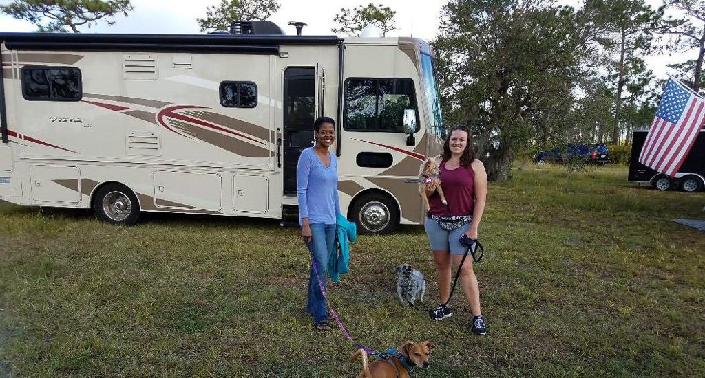 Sabrina and friend walking dogs in front of Vista