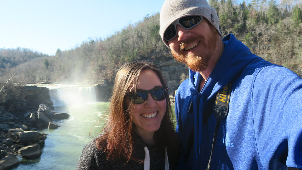 Brooke and Buddy taking selfie in front of waterfall