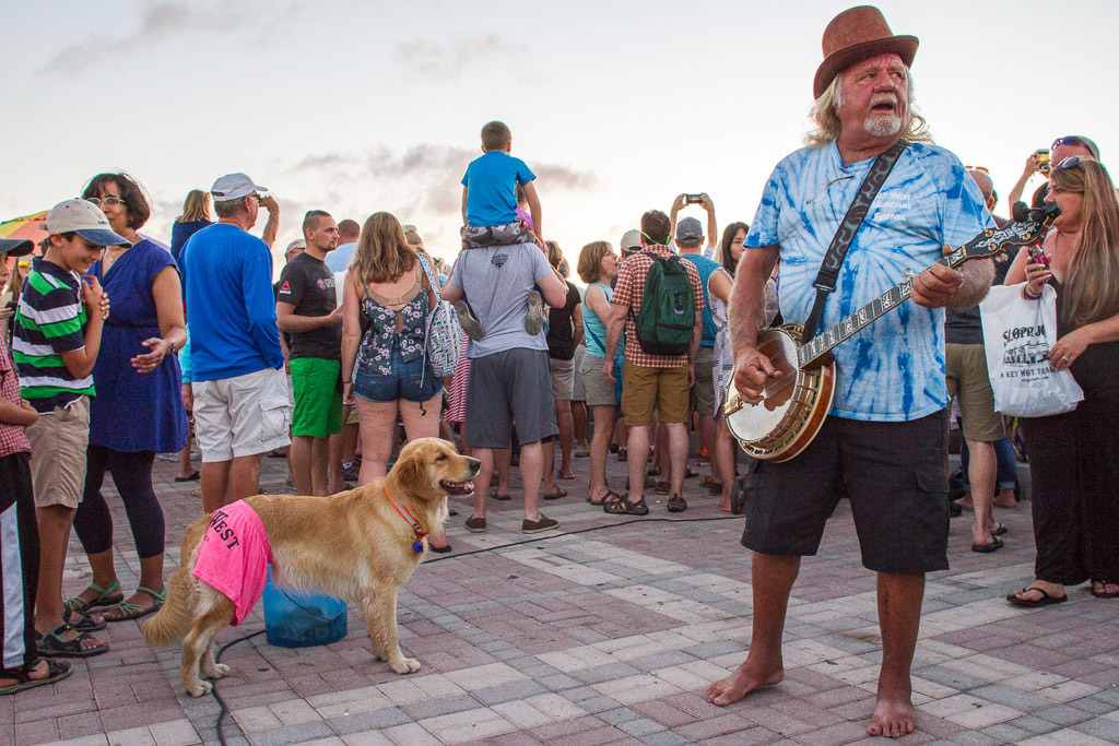 Group of people gathered around street performer