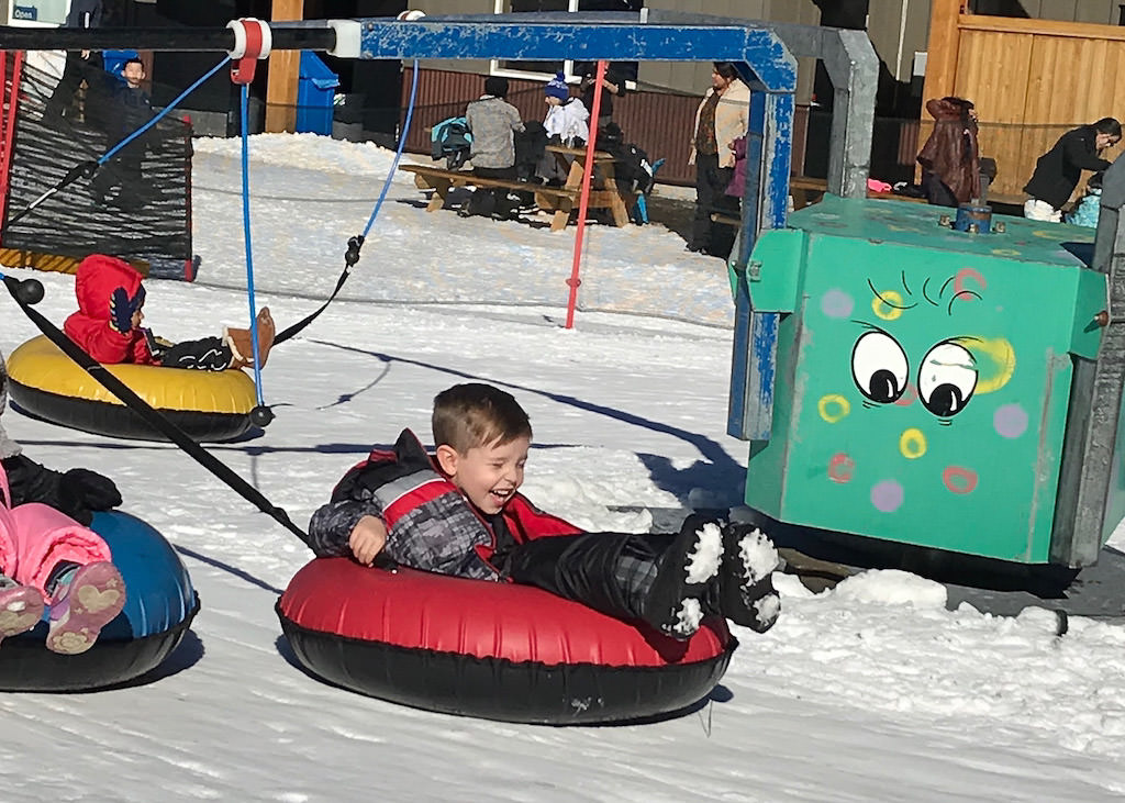 Children on "tubing carousel."