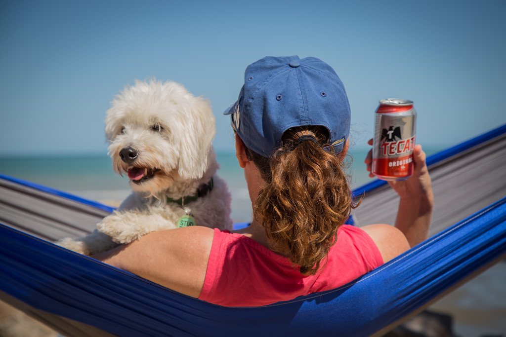 Woman and dog on a hammock