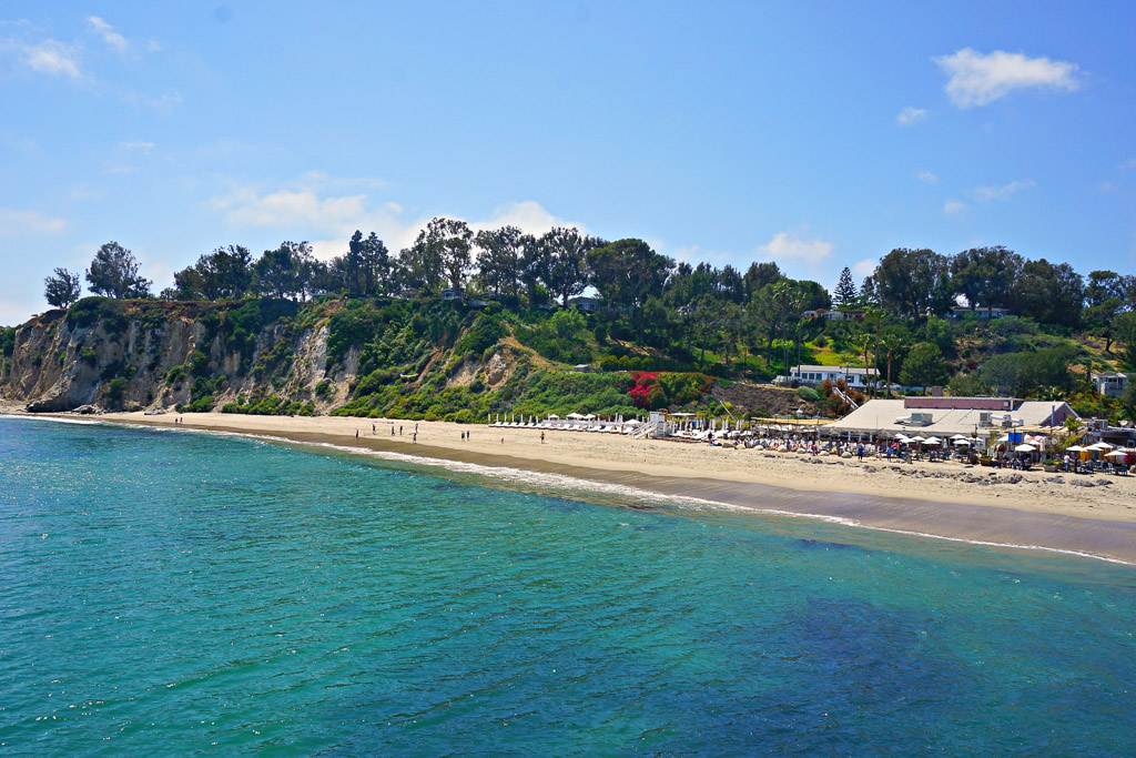 People gathered along the beach at Paradise Cove Beach Cafe
