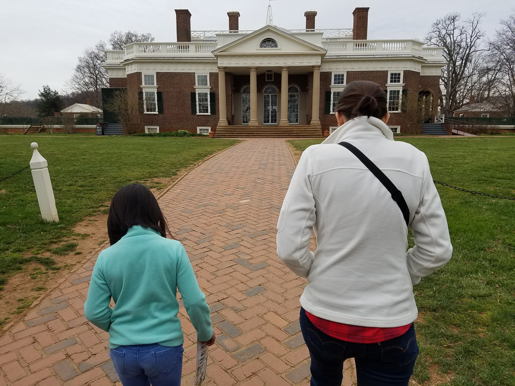 Woman and child walking up to old Victorian style house