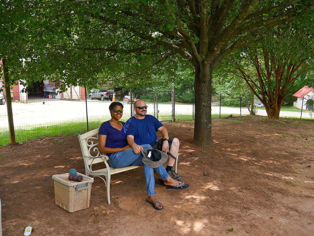 Kenny and Sabrina sitting on a bench in the dog park