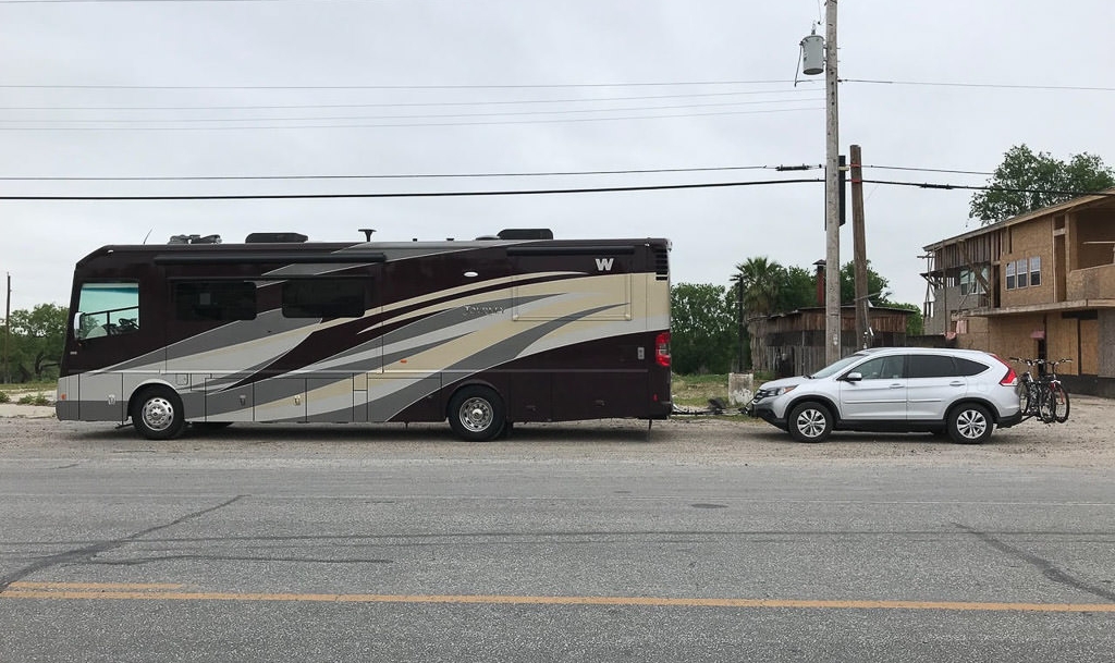 Winnebago Journey pulling tow car pulled over on side of road