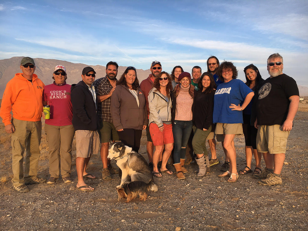 Group of Xscapers and two dogs huddled together for a photo