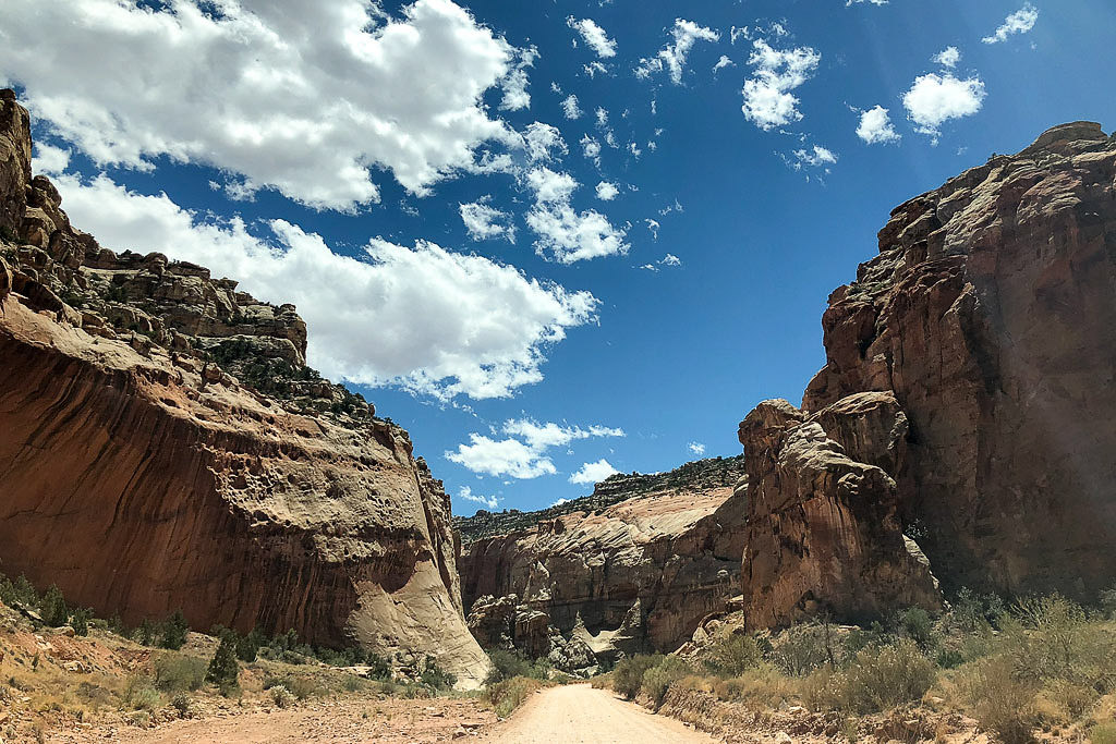 Unpaved road leading through tall rock formations