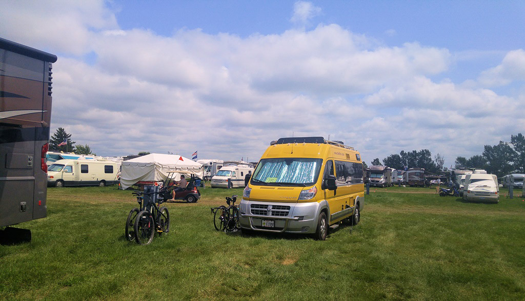 Yellow WinnebagoTravato parked among other motorhomes at Grand National Rally