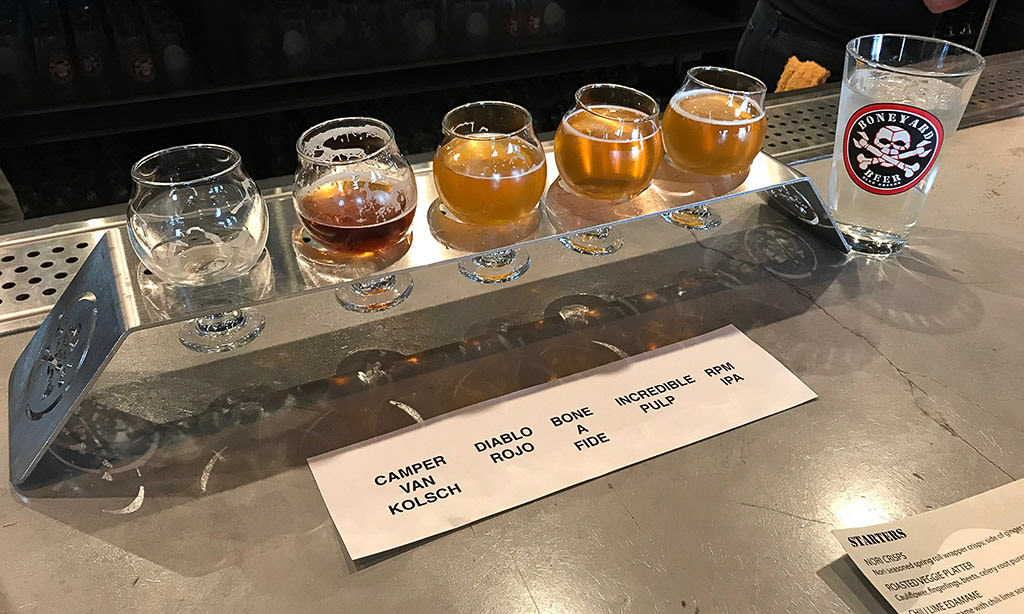 Flight of beer on table at Boneyard Beer.