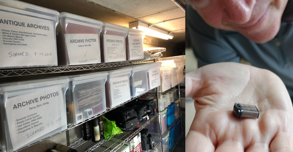 Don holding up memory stick next to bins of photos for comparison