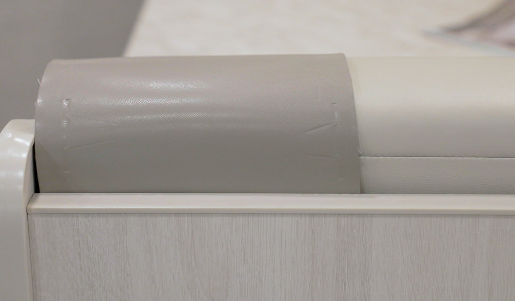 Gray swatch of fabic laid over the couch of the Winnebago Intent.