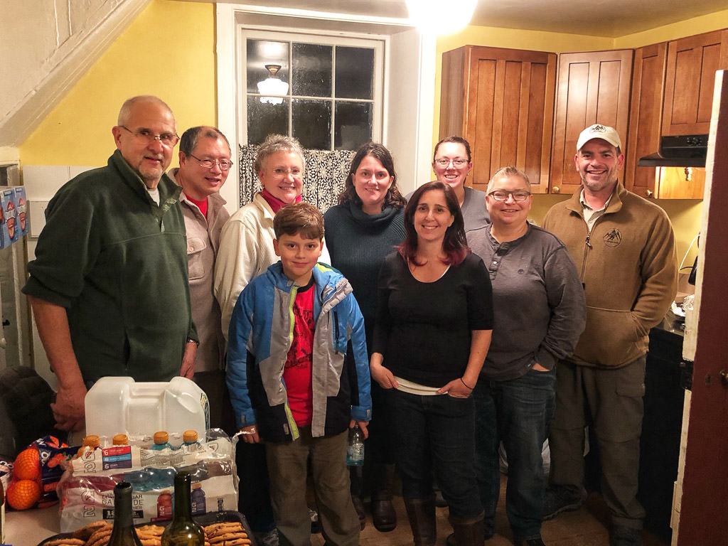 Travato group smiling for picture in kitchen 