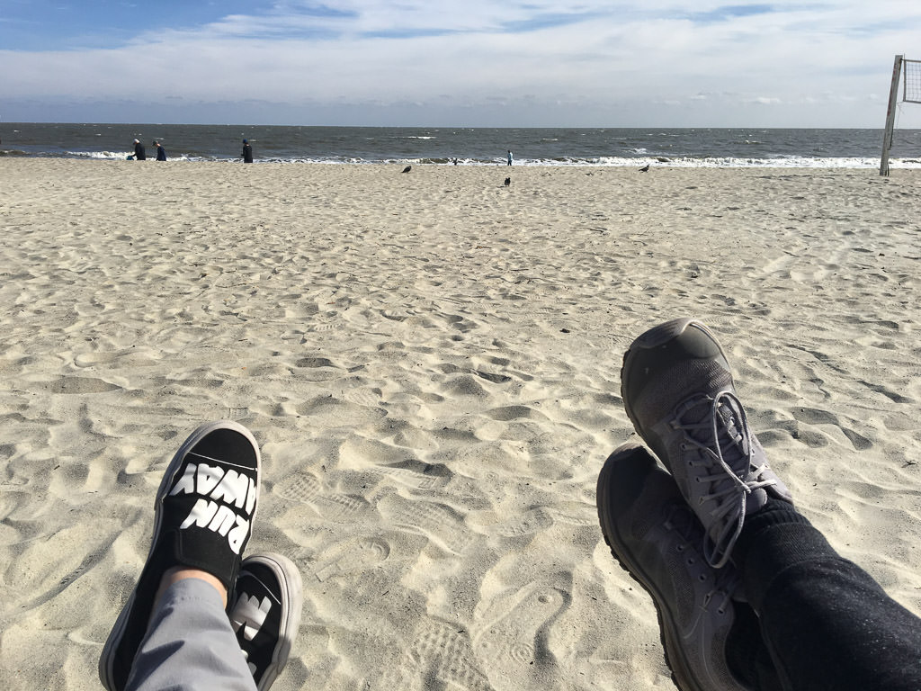 Feet up sitting in the sand at the beach