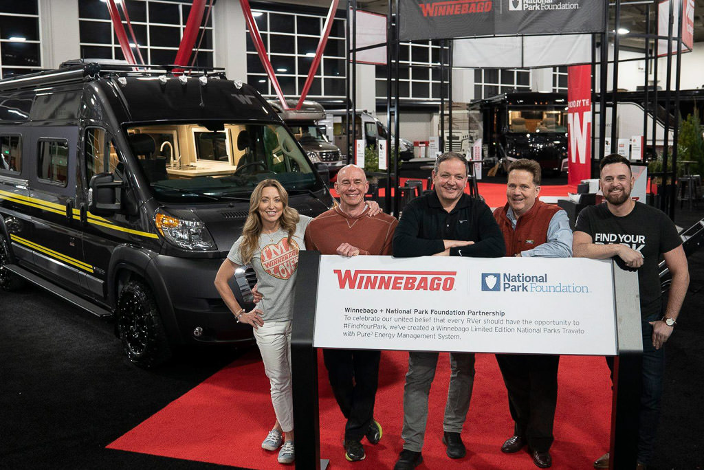 People standing behind display for the Limited-edition National Park Foundation Travato at RVX.