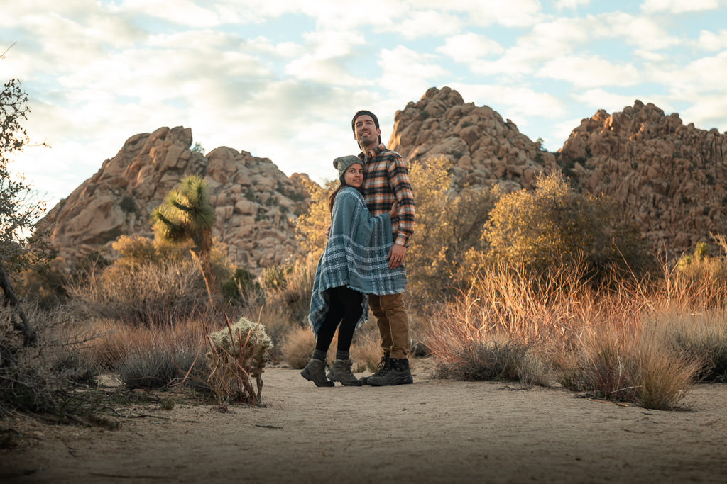 Jon and Nadia posing in front of rock formation.