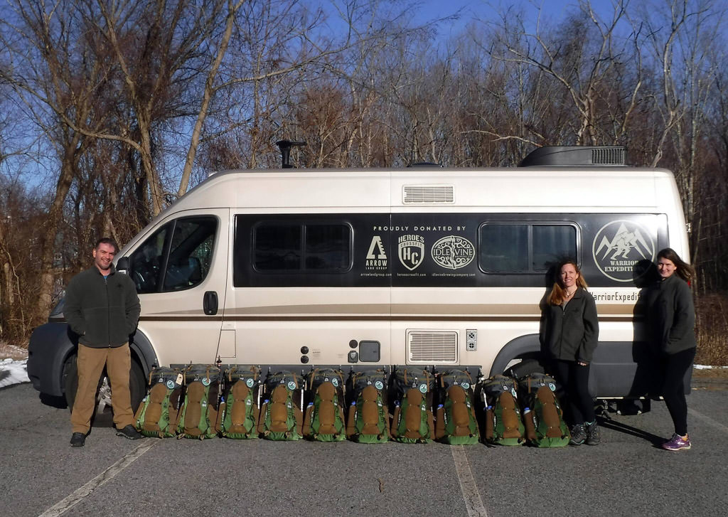Warrior Expeditions team standing in front of Travato with gear