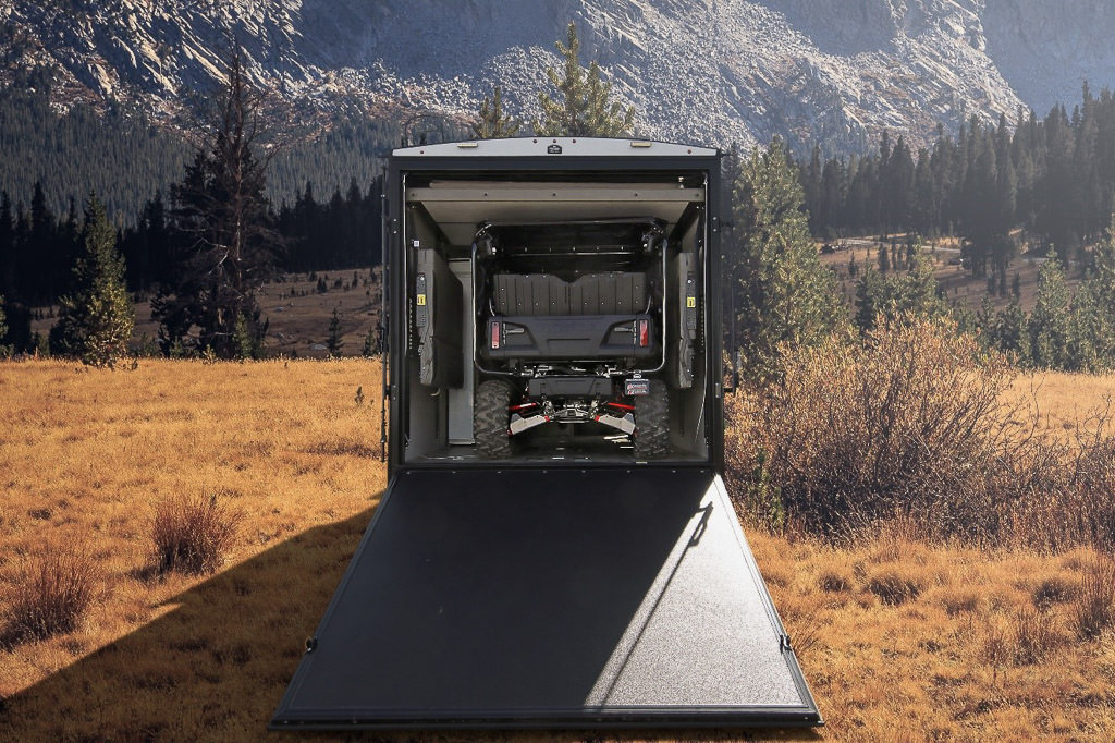 Gator in garage of the Winnebago Spyder parked at the base of a mountain.
