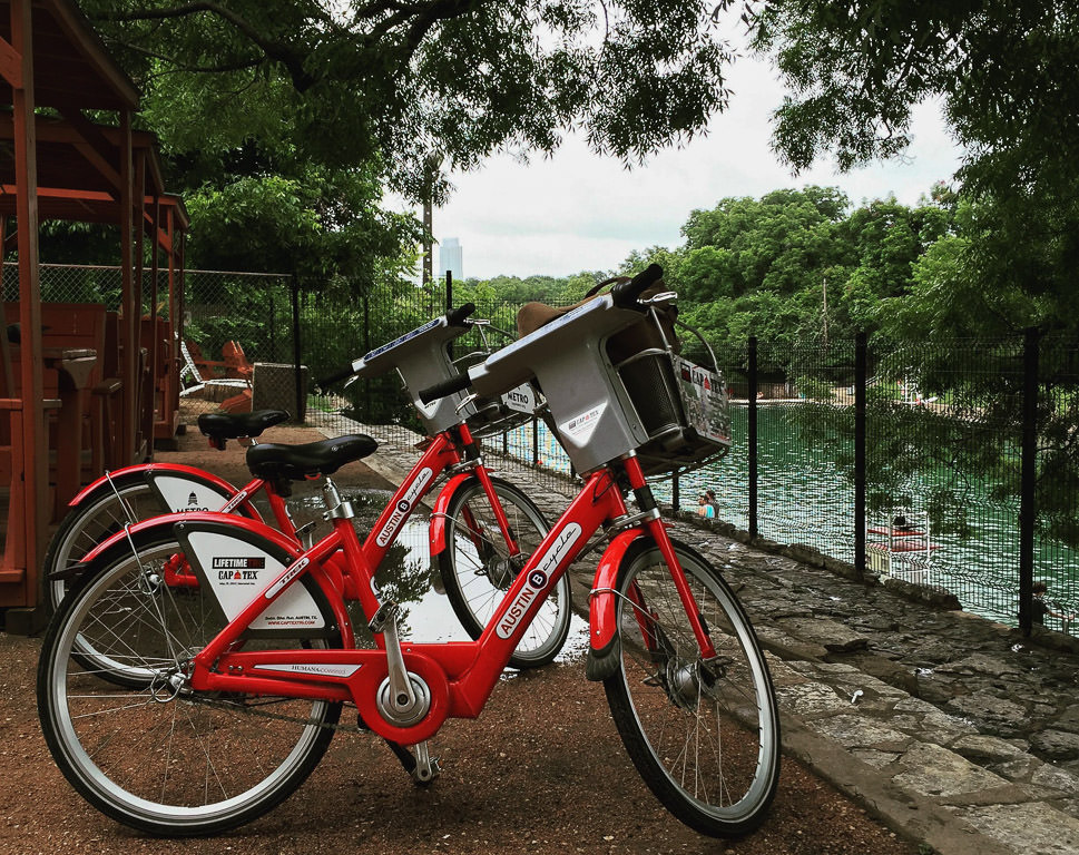 Two bikes parked along the waterway.