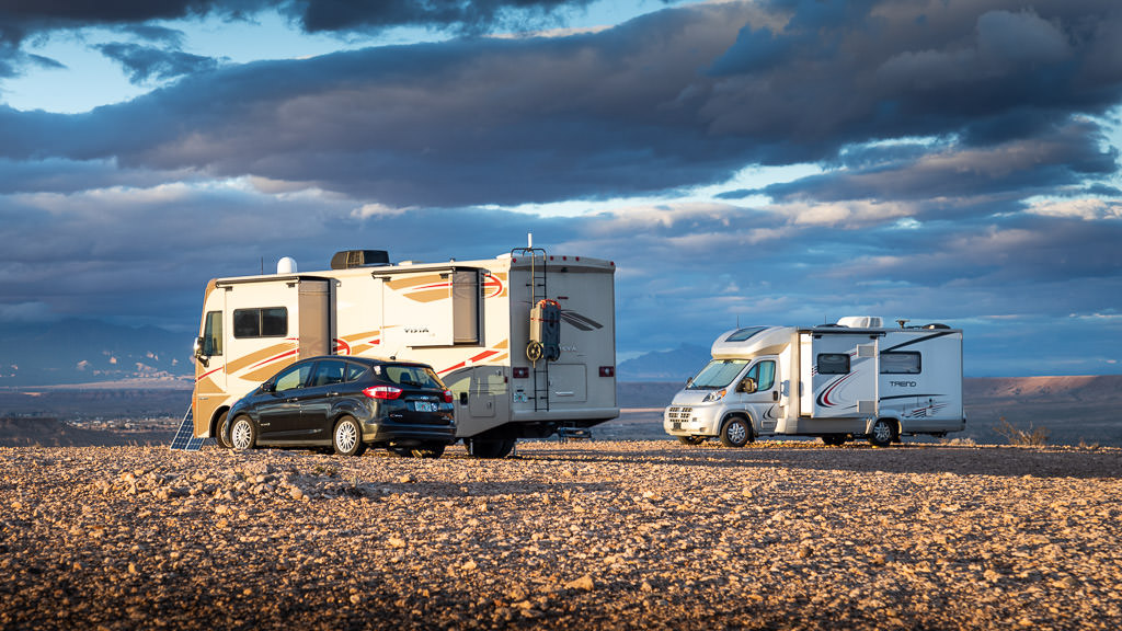 Winnebago Trend and Winnebago Vista parked on rocky ground with nothing else around.